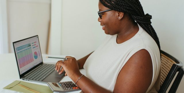 A woman working on reports on a laptop