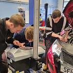 Students working on a vehicle in the motor vehicle workshop