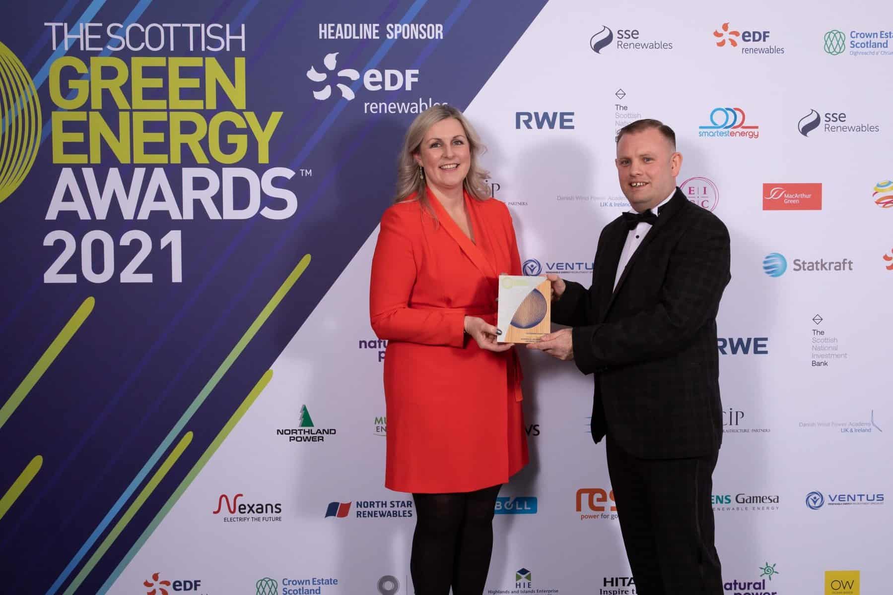 On Thursday 2nd December 2021 the Scottish Green Energy Awards were held at the Edinburgh International Conference Centre with 1100 guests from throughout the renewables energy sector in attendance. The evening was organised by Scottish Renewables, with eDF Renewables as the headline sponsor. The evening was hosted by Jo Caulfield. Pictured is the winner of the Outstanding Project Award won by Dumfries & Galloway College. LHS Joanna Campbell, Dumfries & Galloway College and RHS Billy Currie, Dumfries & Galloway College.