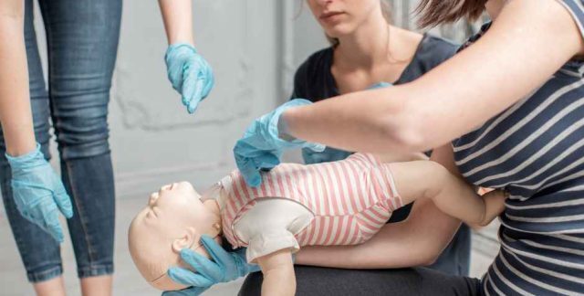 Students practicing Emergency Paediatric First Aid on a dummy of a child