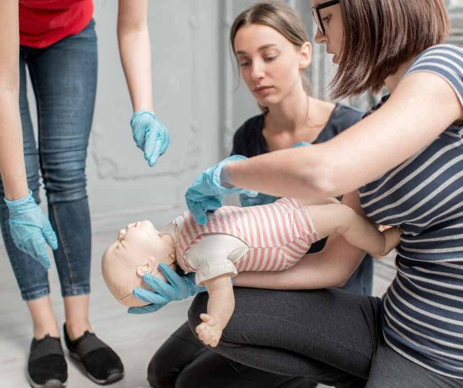 Students practicing Emergency Paediatric First Aid on a dummy of a child