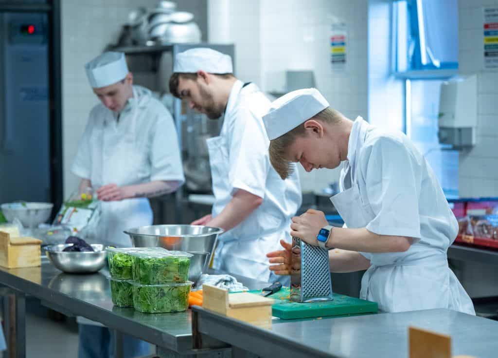 Students at Dumfries and Galloway College preparing food in a commercial kitchen