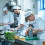 Students at Dumfries and Galloway College preparing food in a commercial kitchen