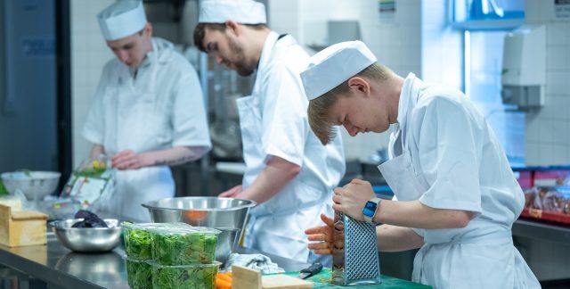 Students at Dumfries and Galloway College preparing food in a commercial kitchen