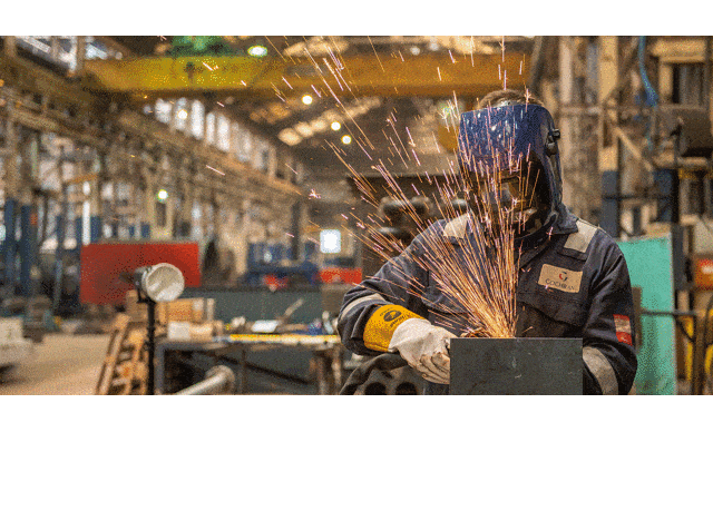 An engineer welding in an industrial workshop