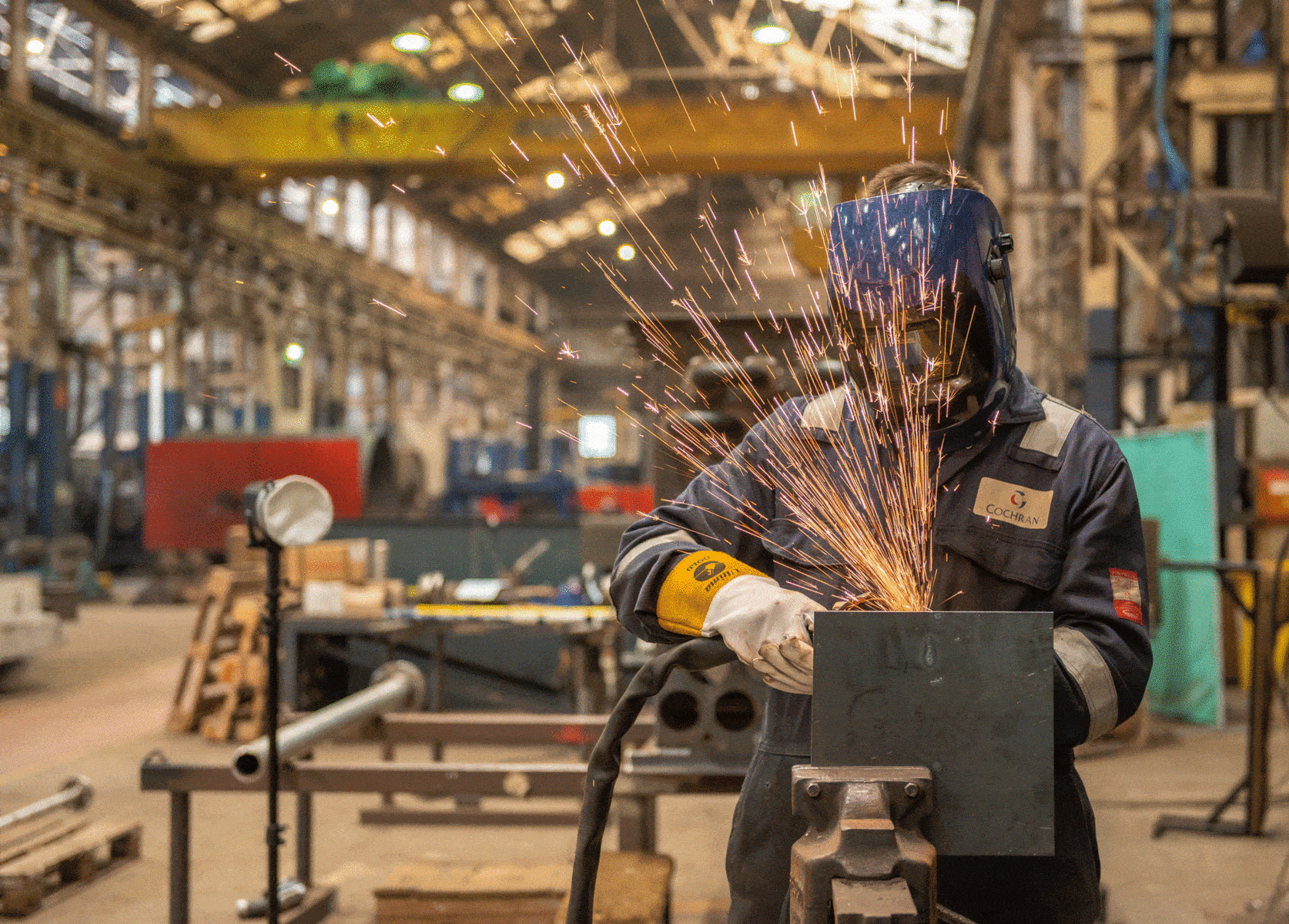 An engineer welding in an industrial workshop