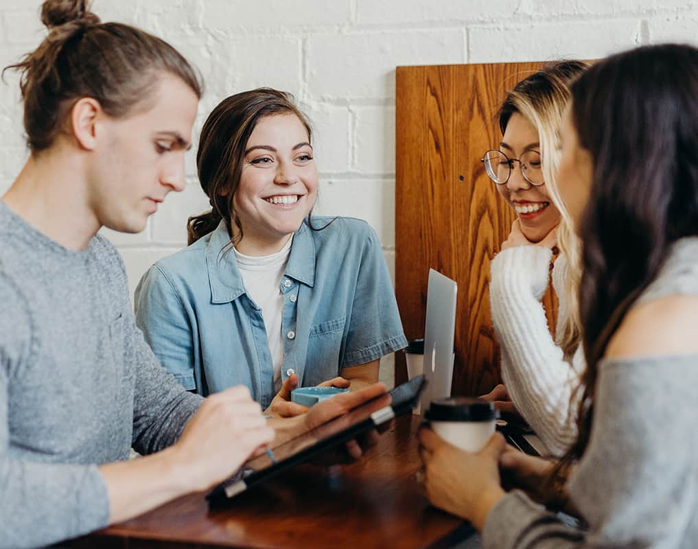 A group of students studying and socialising over some coffee