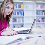 A woman studying at a laptop