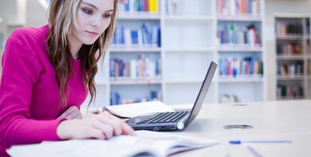 A woman studying at a laptop