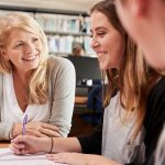 A tutor working with students who are studying