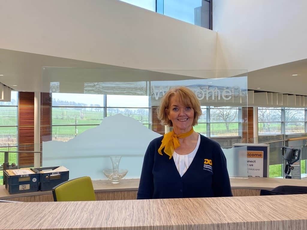 Staff member at the reception desk at Dumfries and Galloway College