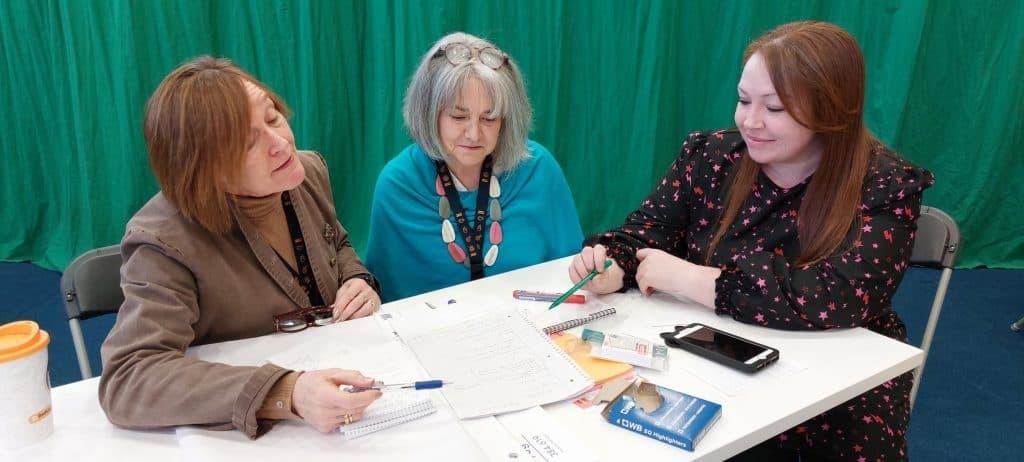 Staff members at Dumfries and Galloway college having a meeting around a table