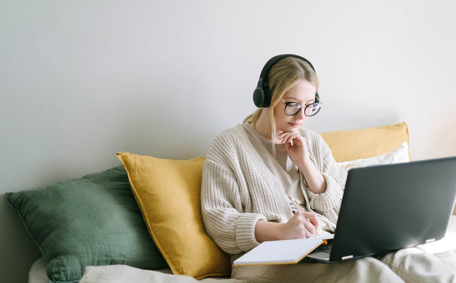 A young woman studying online at home.