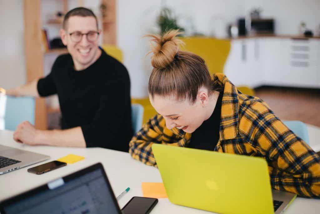 happy students studying on laptops