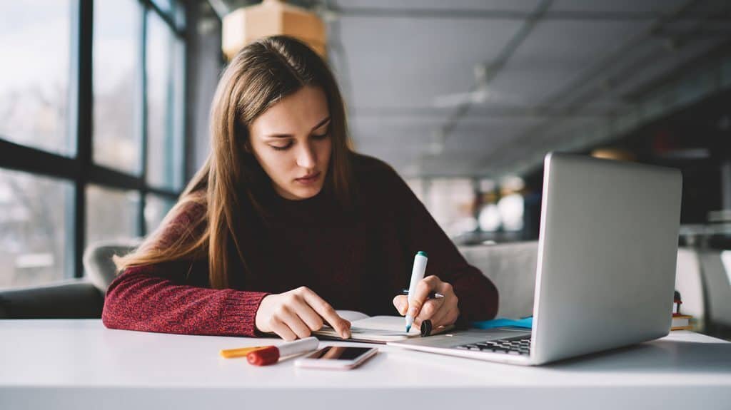 A female student studying at a laptop