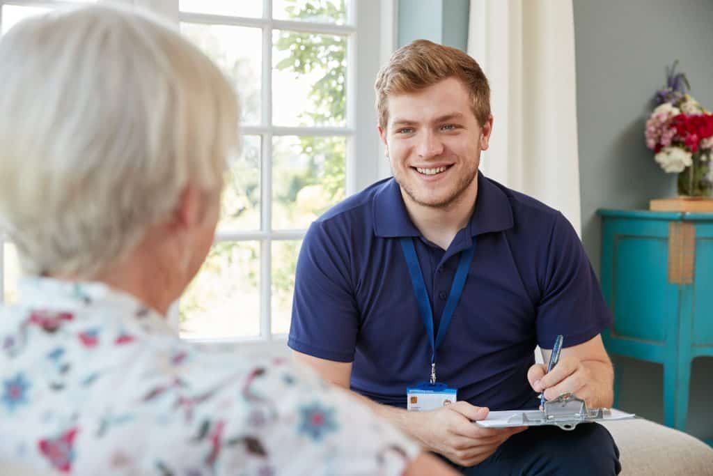 A male carer takes down details