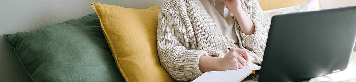 A young woman studying online at home.