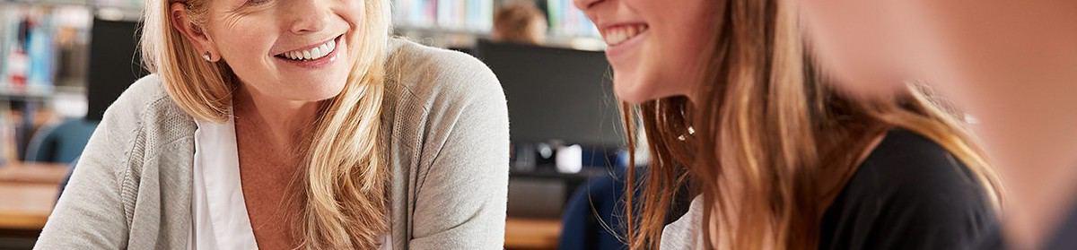 A tutor working with students who are studying